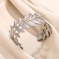 Detailed close-up of a silver stainless steel leaf cuff bracelet on silk fabric - Leaf Branch Shape Style (B1483P)