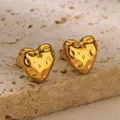 Macro shot of gold heart stud earrings with irregular hammered texture on stone base - Lava Heart Style (G885288) / Gold