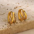 Close-up of gold double hoop earrings with sparkling pavé stones on stone stand - Double Hoop with Zirconia (G8144995(t)) / Gold