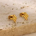 Detailed view of golden triangular beaded cluster earrings on a beige stone background - Grape Cluster Style (G885295) / Gold
