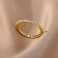 18K gold plated adjustable ring featuring sparkling pavé set zircon stones - Gold Band With White Zirconia Style (JZ4042G-1)