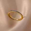 Adjustable 18K gold plated ring featuring a row of pave-set dark blue cubic zirconia stones - Gold Band With Dark Blue Zirconia Style (JZ4042G-3)