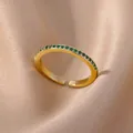 Elegant 18K gold plated ring featuring a sparkling row of round green zircon gemstones - Gold Band With Green Zirconia Style (JZ4042G-4)