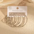 Trois paires de boucles d'oreilles créoles en acier argenté avec texture torsadée - Couleur Acier (1122)