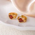 Golden huggie hoop earrings with a red heart-shaped zircon gemstone inlay - Red Heart Style (1424)