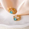 Gold-plated heart earrings featuring sky blue zircon stones on a white marble base - Blue Heart Style (1425)