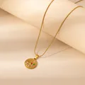 Golden 12 Zodiac necklace featuring red and green star details with white cubic zirconia - Scorpio