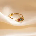 Gold open ring with four marquise-cut colorful zircons on a beige silk background - Colorful Band Style (1672)
