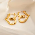 Elegant gold-plated twisted heart stud earrings on beige silk fabric background - Intertwined Heart Earrings 0172