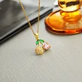 Golden necklace with cherry pendant featuring pink, green, and white gemstones - Pink Cherry Necklace 0367