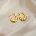 Elegant gold U-shaped hoop earrings with intricate woven texture on silk background - Dotted Teardrop Earrings 0177