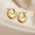 Polished golden stainless steel twisted hoop earrings on soft silk background - Crater Pattern Round Earrings 0261