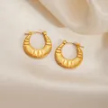 Golden round twisted hoop earrings with radial texture on a soft satin background - Grooved Round Earrings 0268