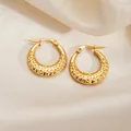 Golden round hoop earrings with hammered texture on elegant beige silk background - Dented Round Earrings 0269