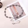 Retro silver metal waist chain with sun pattern oval plates on a minimalist background - Silver Sun Texture Embossed Style