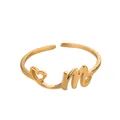 Vue détaillée de la bague dorée ouverte avec cœur évidé et lettre M en cursive - Lettre M