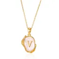 Detail of 18K gold letter V necklace with pink enamel on a molten textured oval pendant - Gold V