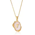 Detailed macro view of 18K gold letter F pendant with textured white resin inlay - Gold F