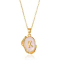 Detailed macro view of 18K gold plated K letter pendant with white enamel on a white base - Gold K