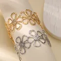 Golden and silver flower cutout cuff bracelets with hammer texture on a display stand - Hollow Flower Shaped Style (B1737) / Gold