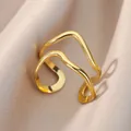 Detail of double-layered wave design golden stainless steel ring on silk fabric - Double Layer Wave Style (G11174184G-30) / Gold