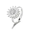 Macro shot of silver rotating flower ring with sparkling zircon petals and 18K gold plating - Silver