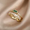 Detail of emerald cut green stone and rectangular zircon baguettes on 18K gold open ring - Double Layer Emerald Zirconia Style (G1072937G-2)