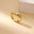 Macro shot of twisted golden ring with pave-set clear zircon and mirror polish detail - Adjustable Open / Golden Spiral Twist Smooth Pave Style (G4127615)