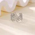 Detailed view of silver stainless steel ring with hollow flower design on stone base - Continuous Daisy Hollow Ring (JZ7646) / Silver