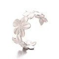 Detailed close-up of silver stainless steel flower cuff with radial brushed metal texture - Style A (187105) / Silver