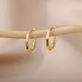 Macro view of gold-plated bamboo-shaped hoop earrings hanging on a natural wooden branch - Bamboo Joint Shape Style (E2308G-4) / 18K Gold / Gold