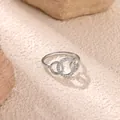 Close-up of interlocking silver geometric rings with sparkling pave zircon settings - Silver (P9128545)