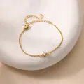 Minimalist 18K gold plated bracelet with a sparkling round zircon on a white plate - Gold