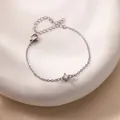 Macro shot of minimalist silver chain bracelet with round zircon and adjustable lobster clasp - Silver