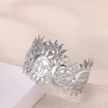 Detail view of silver hollow sun face relief design on stainless steel open bangle - Sun Face Style (P10302146) / Silver