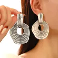 Close-up of geometric antique silver earrings with irregular concentric circle texture - Antique Silver Concentric Circle (A-534)