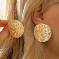 Chunky gold irregular round stud earrings with a hammered texture finish on model - Gold Vintage Round Hammered Texture Style (9109)
