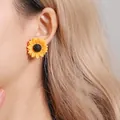 Bohemian sunflower stud earrings with yellow petals and black center on a model - Sunflower Stud / Yellow