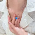Star pendant necklace with vibrant blue opal star and silver charm on model - Blue Double Star Style (01 White K Blue WG-1365)