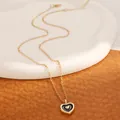 Elegant gold and black enamel heart pendant necklace on a refined ceramic base - KC Gold Black Heart Necklace