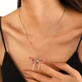 Elegant silver satellite chain necklace with a hollow bow pendant and pearl details - Hollow Bow Beaded Chain Necklace (N-393) / Silver