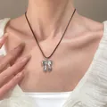 Elegant silver bow pendant on a minimalist black cord necklace worn by a model - Silver Bow Black Cord Choker (N-099) / Silver/Black