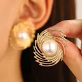 Vintage golden spiral swirl earrings featuring a central white pearl accent - Spiral Texture Artificial Pearl (6471) / Gold