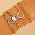 Close-up of a 4-piece gold bracelet set featuring a moon charm and a large crystal - Gold (3040)