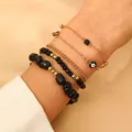 Four-piece stacked black and gold bead bracelet set with evil eye charm on model - 08 Black (5-Strand Set/5292)