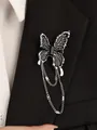 Detail of dark butterfly brooch with black enamel wings and long silver tassels on a suit jacket - Butterfly Tassel Brooch (DZ-681)