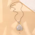 Macro detail of silver leaf pendant with sparkling rhinestones on twisted chain necklace - Silver Tone Style (04 White K DZ-879)