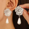 Close-up of vintage silver floral earrings with layered petals and white teardrop pearls - Floral Pearl (N-401)