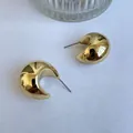 Minimalist chunky gold crescent hoop earrings with a polished metallic mirror finish - Kc Gold N-503