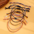 Detail of multi-colored Bohemian hand-woven rope bracelets with adjustable sliding knots - Dark Color Set